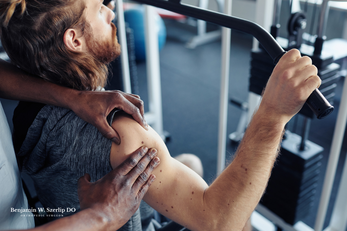 An athlete doing shoulder exercises with the help of a physical therapist to assist in recovery after getting injured in Texas.