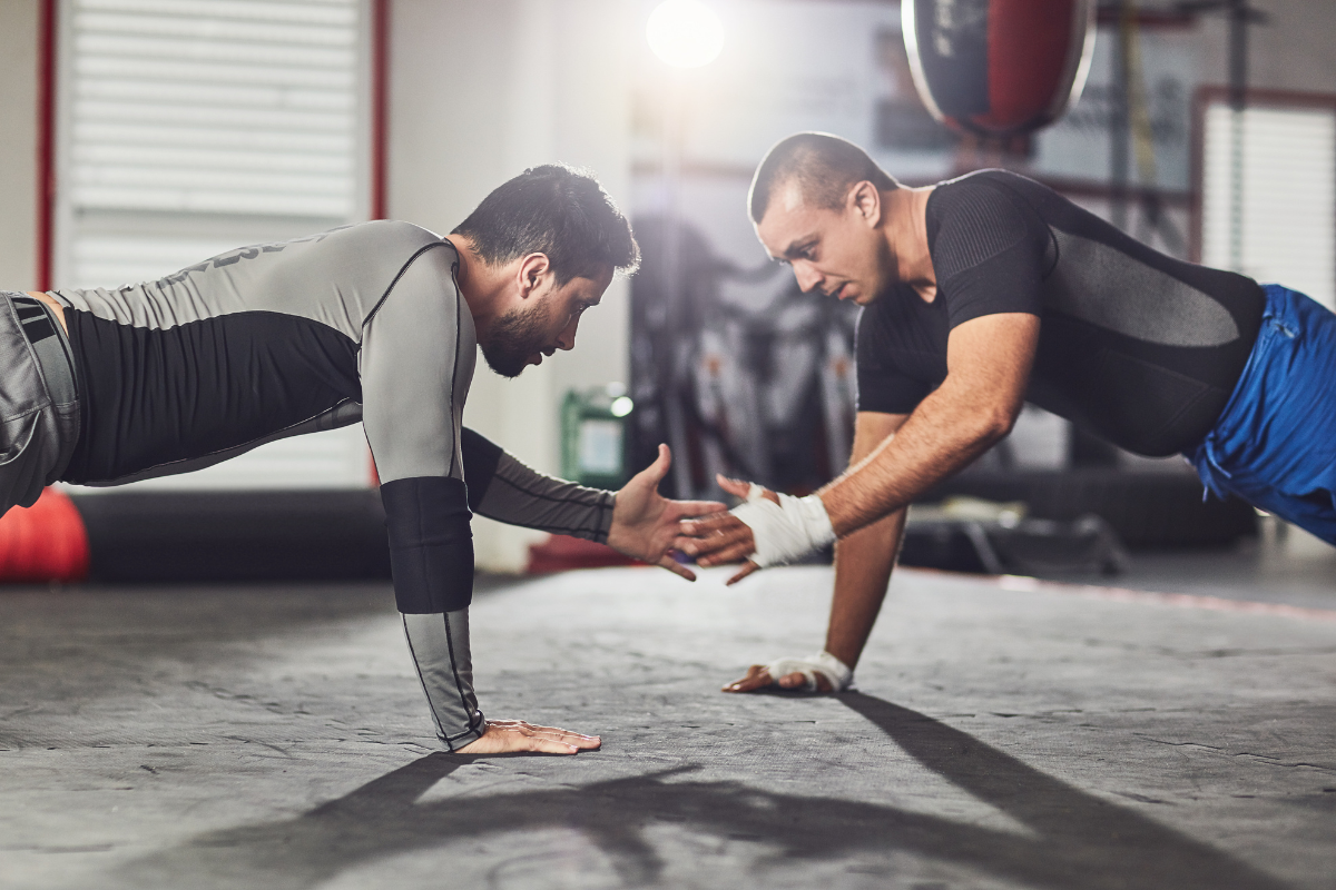 Two professional wrestlers are exercising together to increase shoulder strength and stability in case of injury in Austin, Texas.