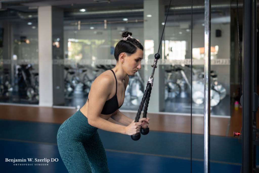 A woman doing resistance training for her triceps after recovering from a tear in Texas.